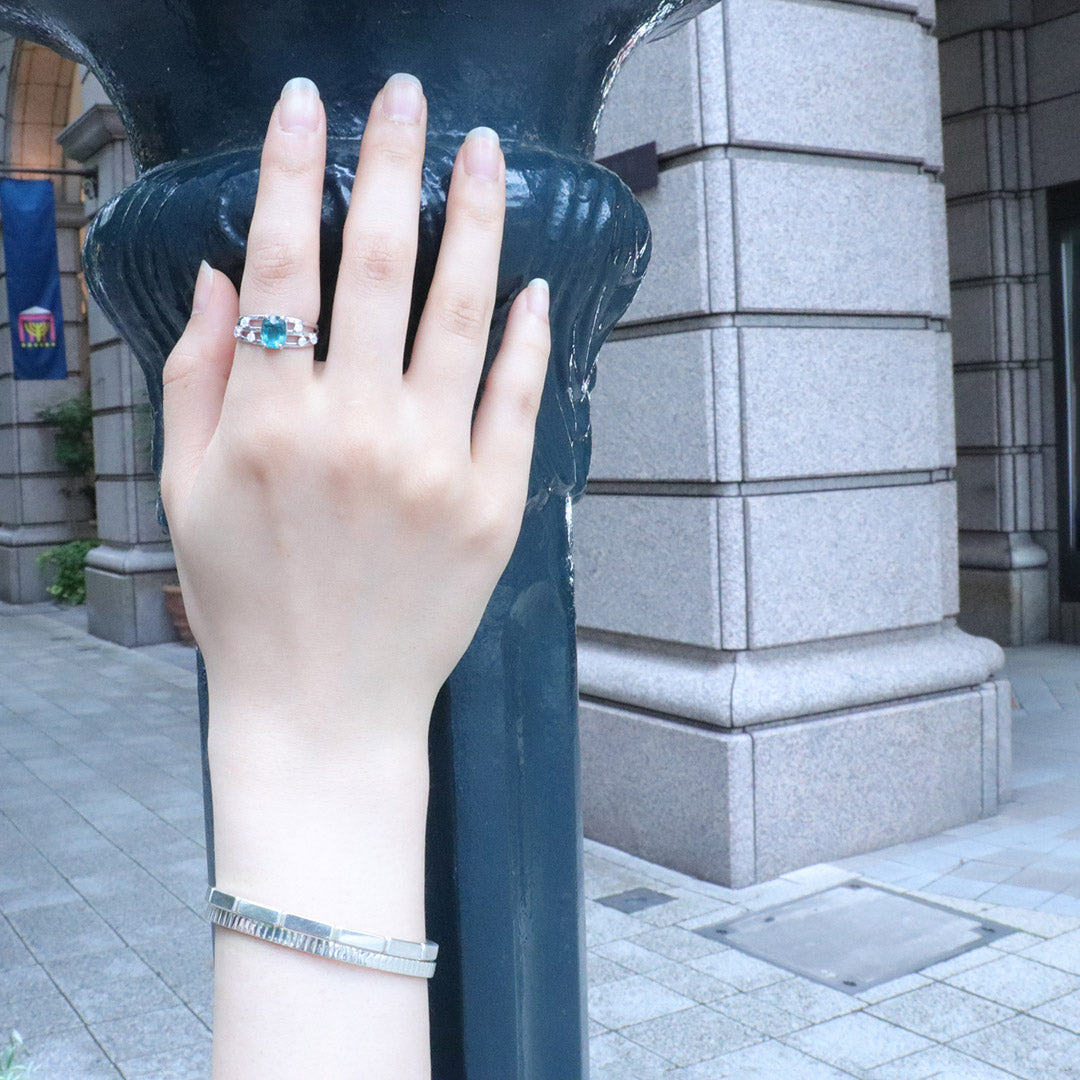 2024.05.05- A hand adorned with a Japanese bamboo bangle rests on a pole